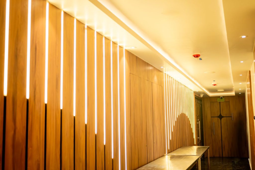Wood-slat corridor with linear lighting