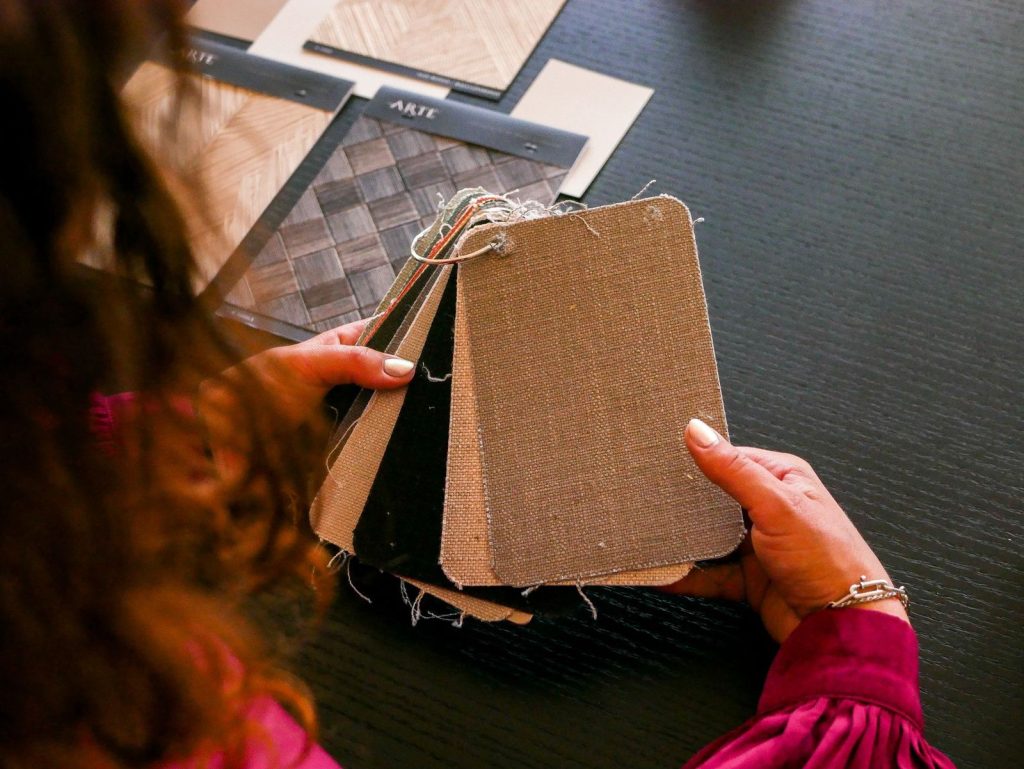 A designer holding material samples